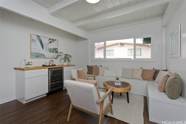 living area featuring beverage cooler, wood ceiling, dark wood-type flooring, wet bar, and beam ceiling