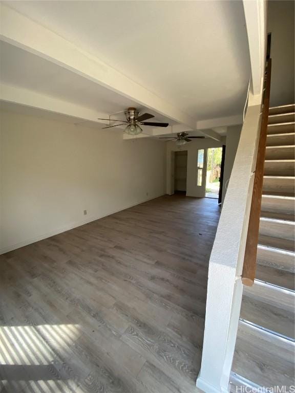 interior space with a ceiling fan, stairway, beam ceiling, and wood finished floors