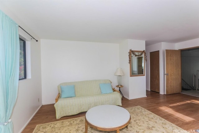 living area with wood finished floors and baseboards