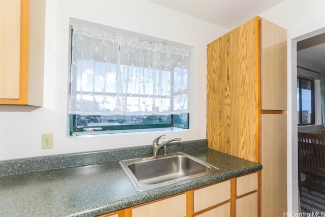 kitchen with a sink and dark countertops