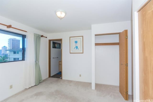 unfurnished bedroom featuring a closet and carpet flooring