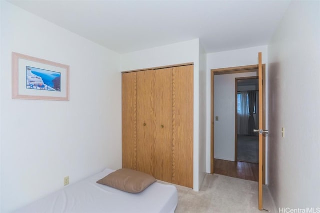 bedroom featuring a closet and light carpet