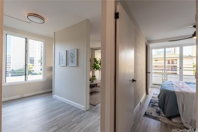 bedroom with baseboards and wood finished floors