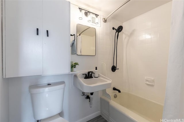 full bath with shower / tub combo, a sink, and toilet