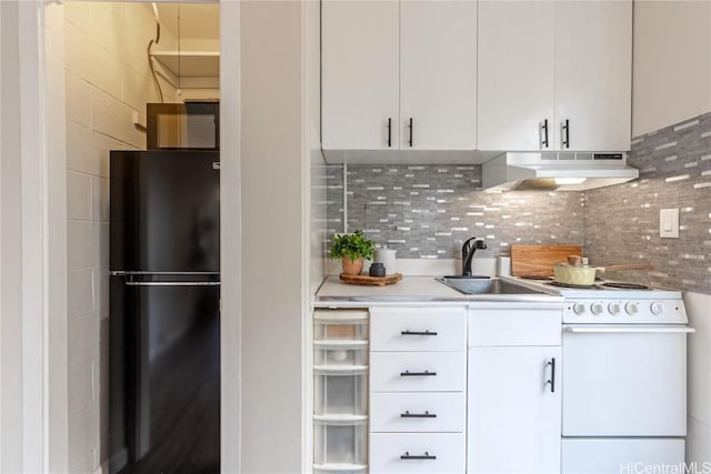 kitchen with white range with electric stovetop, white cabinets, freestanding refrigerator, under cabinet range hood, and a sink