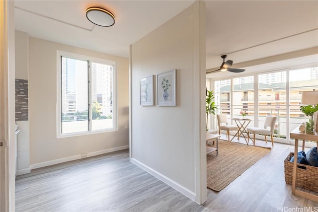 interior space with baseboards and wood finished floors