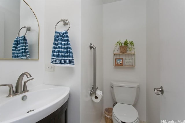 half bathroom featuring toilet and vanity