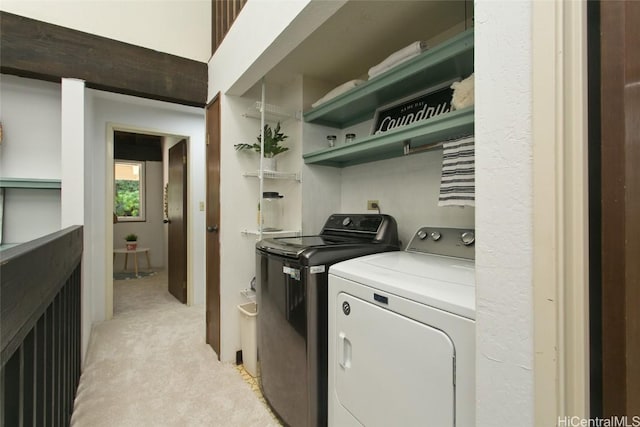 washroom with laundry area, light carpet, and washer and clothes dryer