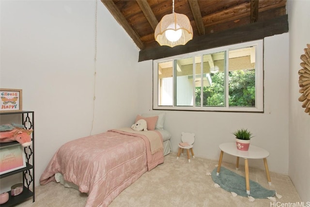 carpeted bedroom with beam ceiling and wood ceiling