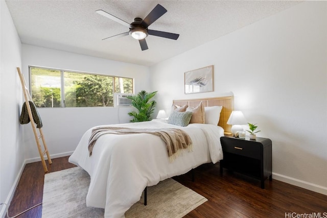 bedroom featuring a textured ceiling, a ceiling fan, baseboards, and wood finished floors