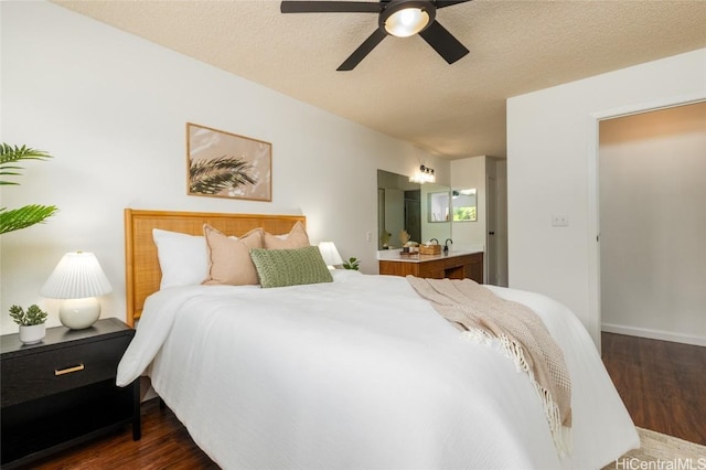 bedroom with a textured ceiling, dark wood finished floors, and a ceiling fan