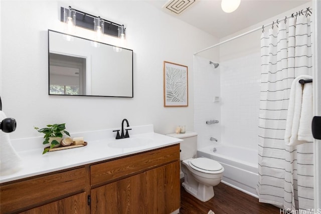 full bathroom featuring vanity, wood finished floors, shower / bathtub combination with curtain, visible vents, and toilet