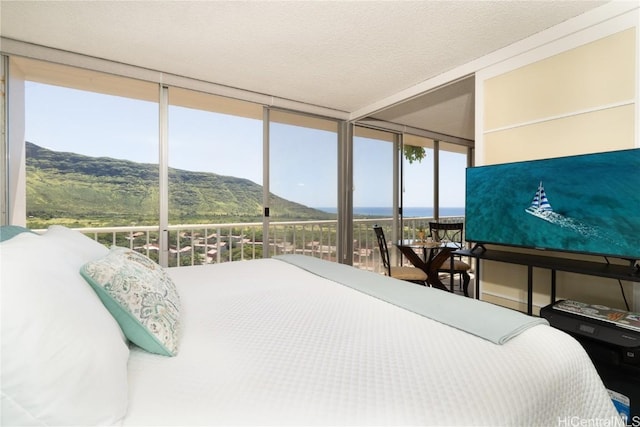 bedroom featuring expansive windows and a textured ceiling