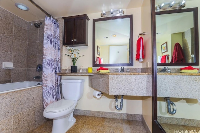 bathroom with tiled shower / bath combo and toilet