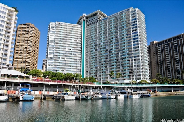 view of building exterior with a water view and a view of city