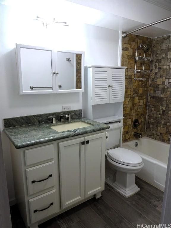 full bathroom featuring  shower combination, toilet, wood finished floors, and vanity