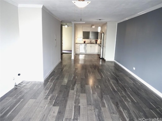 interior space with a sink, baseboards, dark wood finished floors, and crown molding