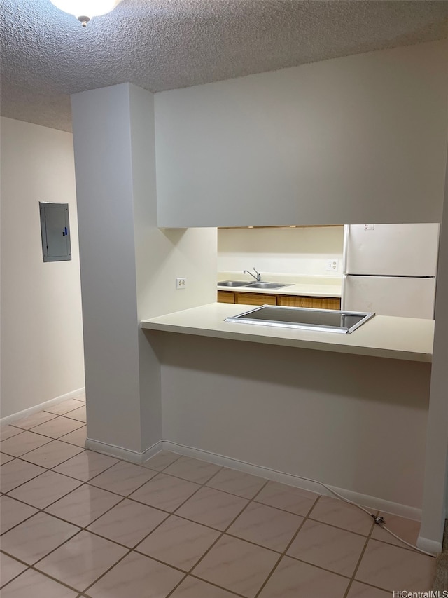 825 Coolidge St Unit 311, Honolulu, HI 96826 - kitchen with freestanding refrigerator, electric panel, a sink, a textured ceiling, and black electric cooktop
