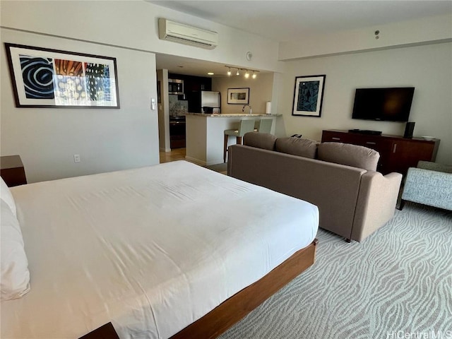 bedroom featuring a wall unit AC and freestanding refrigerator