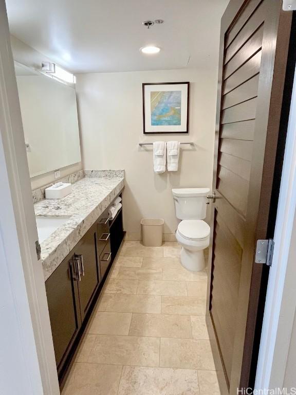 half bathroom featuring toilet and vanity