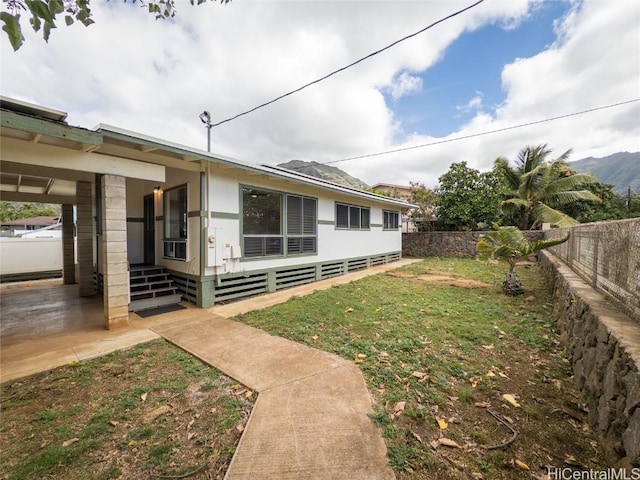 view of yard with entry steps and a fenced backyard