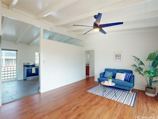 living area featuring a ceiling fan, lofted ceiling with beams, baseboards, and wood finished floors