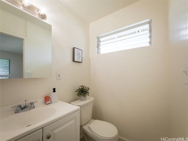 half bathroom with vanity and toilet