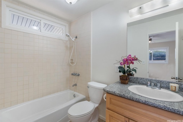 bathroom featuring toilet, vanity, ceiling fan, and shower / bathing tub combination