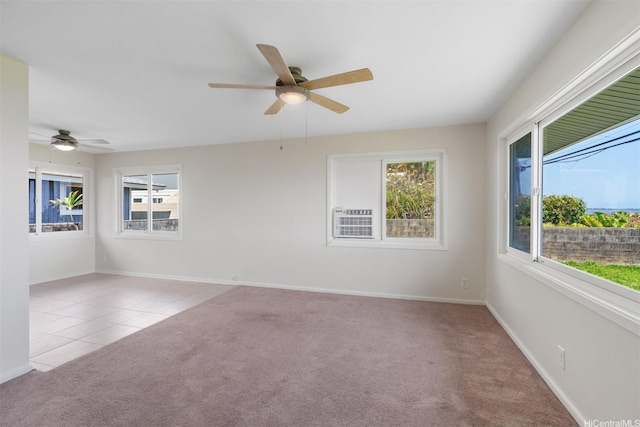 tiled spare room featuring a wealth of natural light, a ceiling fan, and carpet flooring