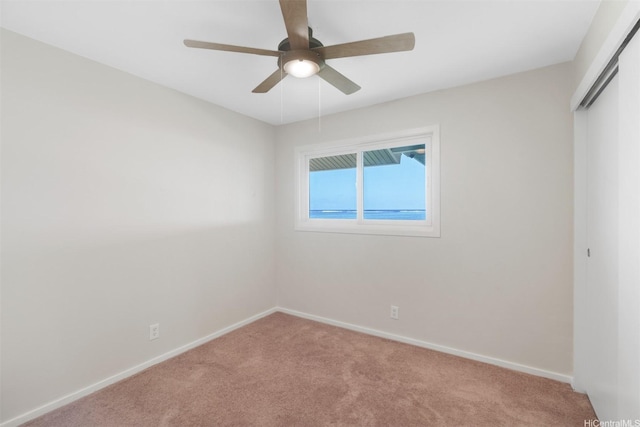unfurnished bedroom featuring baseboards, a closet, a ceiling fan, and carpet floors