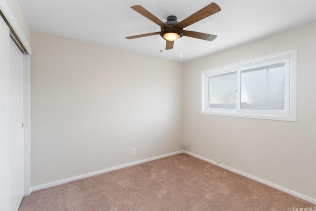 unfurnished bedroom with ceiling fan, a closet, baseboards, and carpet