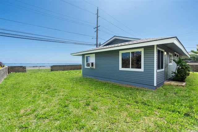 view of side of property featuring a lawn and cooling unit