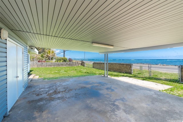 view of patio / terrace featuring a water view and a fenced backyard