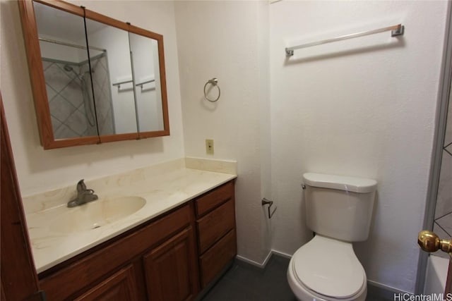 bathroom with baseboards, toilet, and vanity