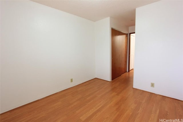 unfurnished room with light wood-type flooring