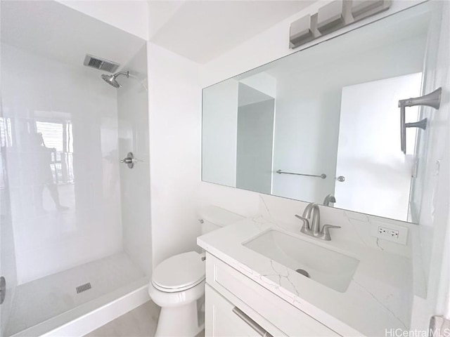 bathroom featuring a stall shower, visible vents, vanity, and toilet