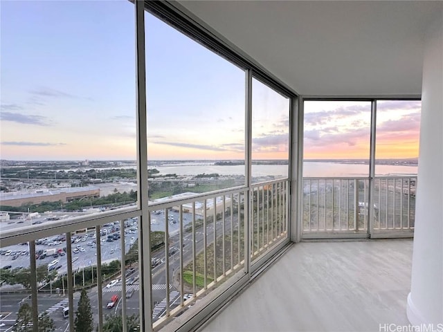 unfurnished sunroom with a water view