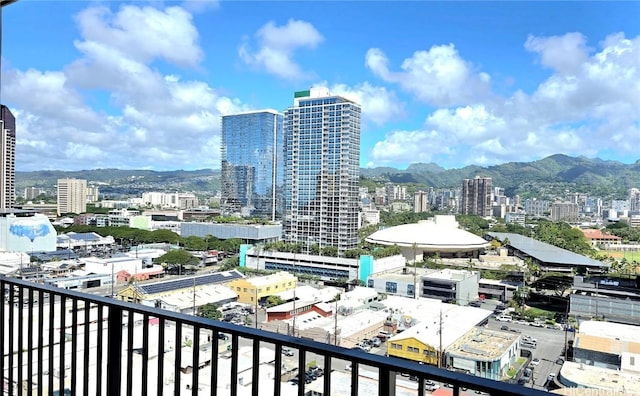 balcony with a mountain view and a view of city