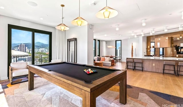 playroom featuring baseboards, pool table, and light wood finished floors