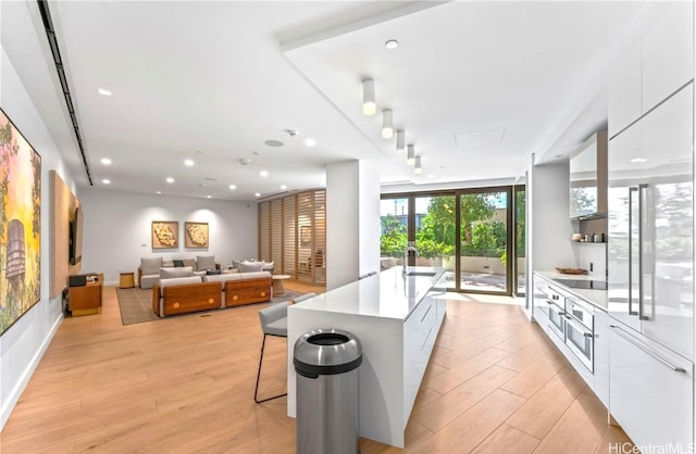 kitchen featuring white cabinetry, light wood-style flooring, recessed lighting, and modern cabinets