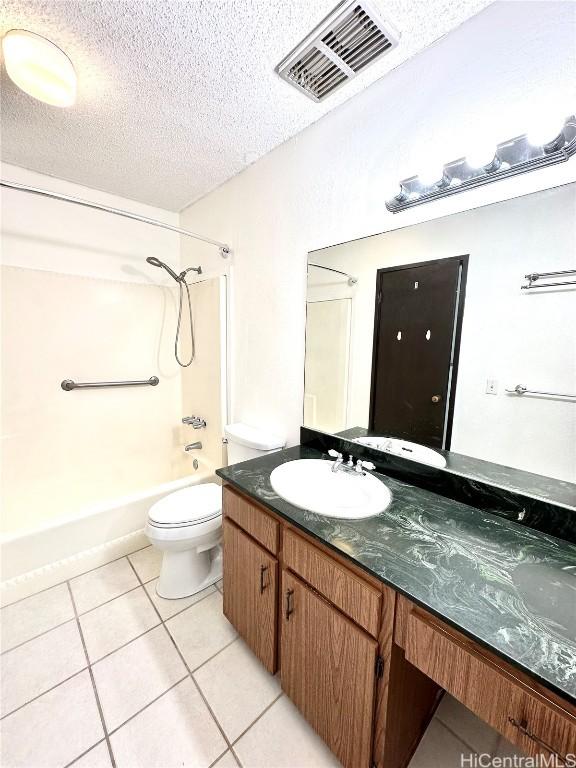 full bath featuring vanity, visible vents, tile patterned flooring, a textured ceiling, and toilet