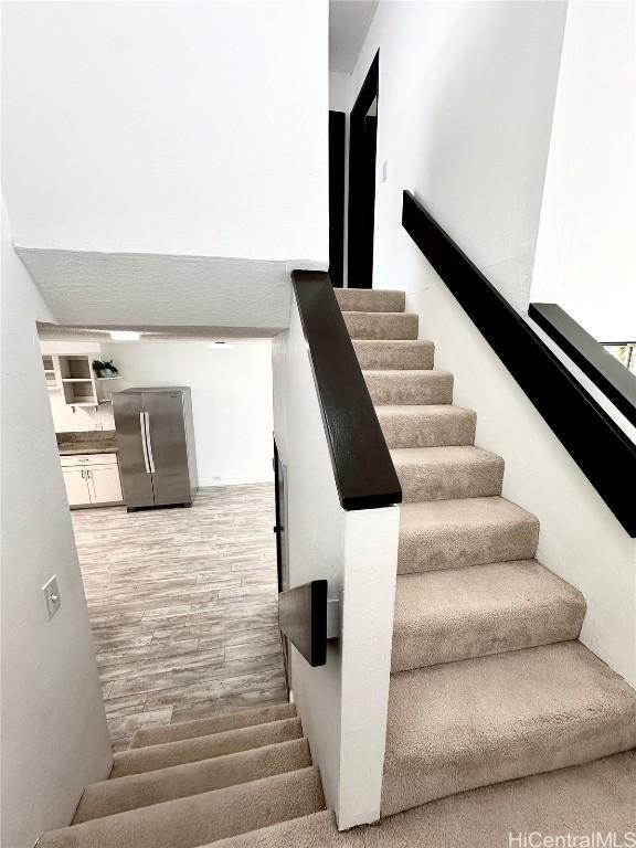 staircase featuring wood finished floors