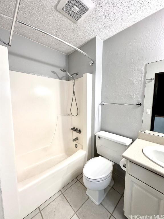 full bathroom featuring visible vents, toilet, shower / bathing tub combination, vanity, and a textured wall