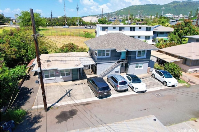 view of front of property with a mountain view and stairway