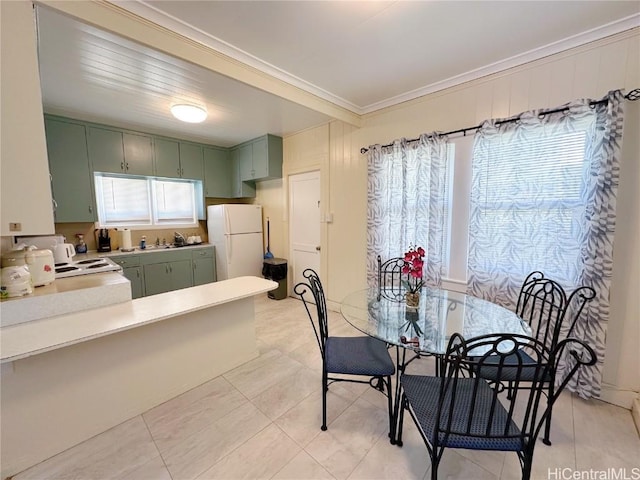 dining space with crown molding