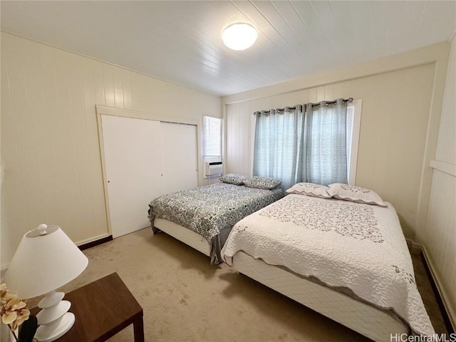 bedroom featuring light carpet, cooling unit, and a closet