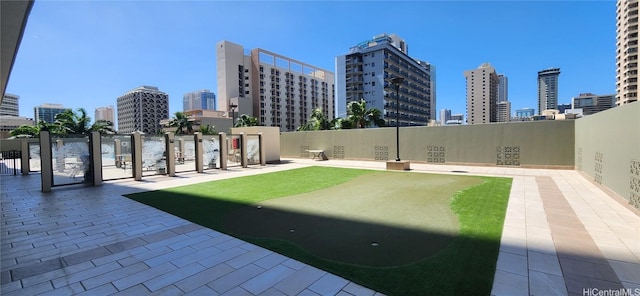 view of yard with fence and a city view