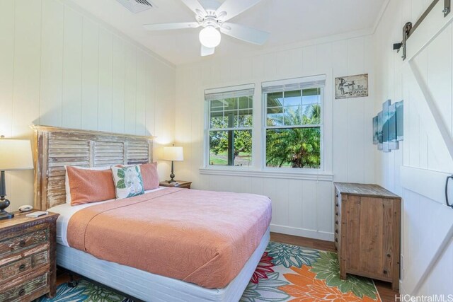 5395-B Loi Pl Unit 1, Koloa, HI 96756 - bedroom featuring visible vents, baseboards, ornamental molding, wood finished floors, and a barn door