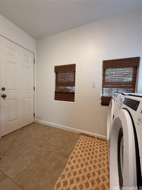 washroom with baseboards, laundry area, independent washer and dryer, and tile patterned floors