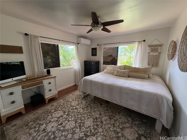 bedroom featuring ceiling fan, multiple windows, a wall mounted air conditioner, and wood finished floors